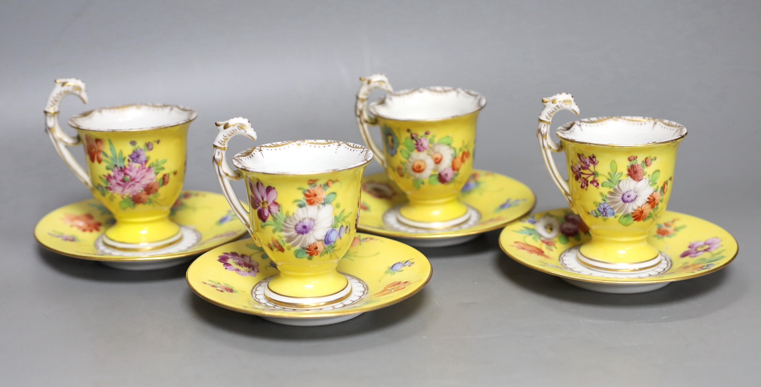 A set of four Dresden yellow ground cups and saucers